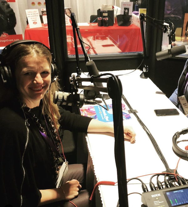 a white woman in a podcast booth